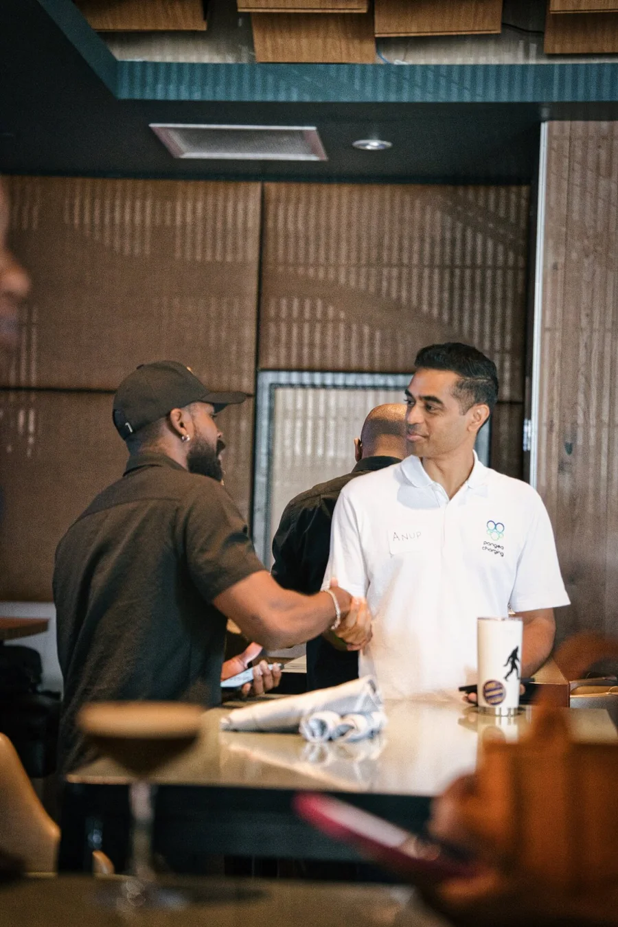 Two guests shaking hands at Small Talk at Moxies