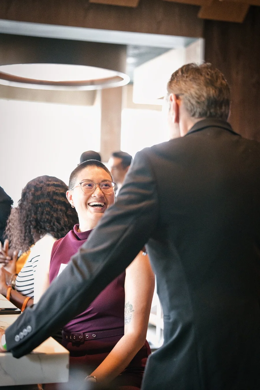 A guest laughing during a Small Talk conversation at Moxies